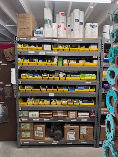 Supply shelves with parts bins and filter rolls