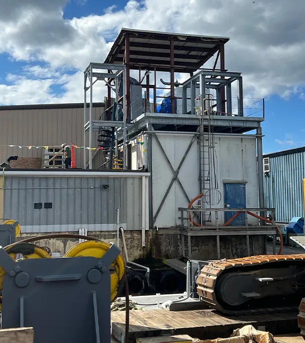 Outdoor industrial refrigeration facility with heavy machinery yard